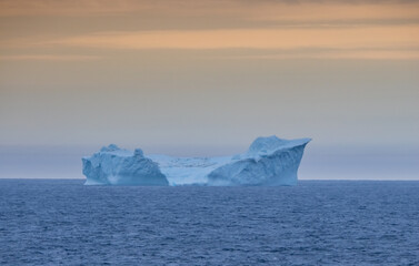 Navigating among gigantic icebergs along the Western coast of Greenland during the midnight sun