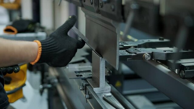 Operator working cut and bending metal sheet by high precision metal sheet bending machine, cnc control metal sheet bending machine in factory