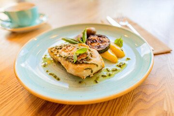 Chicken breast grilled with pesto sauce and vegetables
