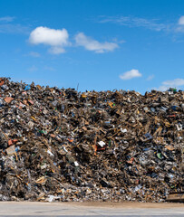 large pile of scrap metal and waste at a recycling plant