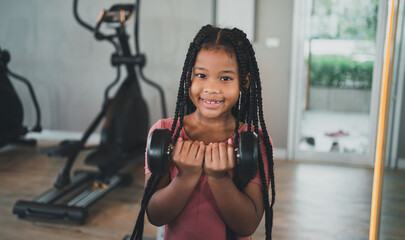 children exercise yoga with family at the gym.The lifestyle of a young body is to take care of one's body.Children wear sports wear to exercise fluently.