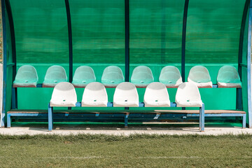 a bench on the green field, football stadium bench for team, Reserve and staff coach bench in sport...