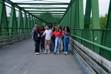 Group of young people walking through a bridge outdoors lifestyle