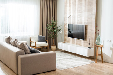 Living room in a modern apartment with a convenient arrangement of furniture