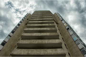 Bottom view of a tall residential building.