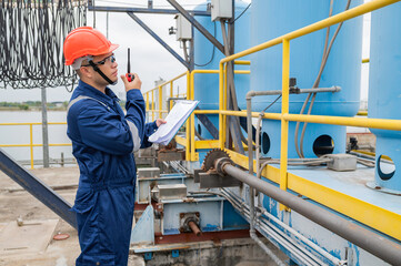 Water plant maintenance technicians, mechanical engineers check the control system at the water treatment plant.