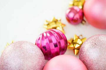 Fototapeta na wymiar Pink Christmas balls on a light background, New Year's decorations, macro photography. Merry Christmas and Happy New Year .