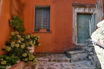 Fototapeta na wymiar The door of an old house in Calitri, a picturesque village in the province of Avellino in Campania, Italy.