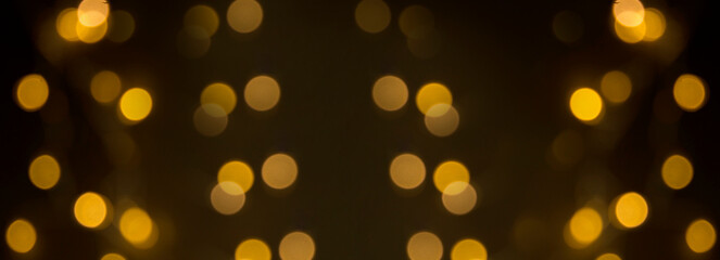 Holiday black background of glowing garland. Banner.