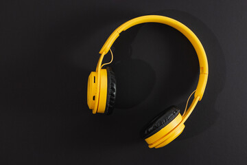 Yellow headphones on black background