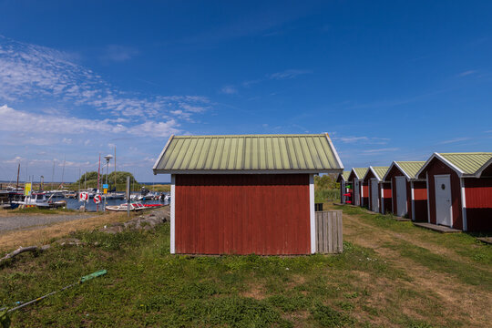 Scenic wooden huts at the picturesque harbor at the Swedish coastal town of Kivik.