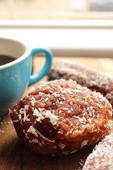 coffee and koesister. Traditional South African sweet snack. Coconut covered doughnuts usually eaten on a Sunday morning. 