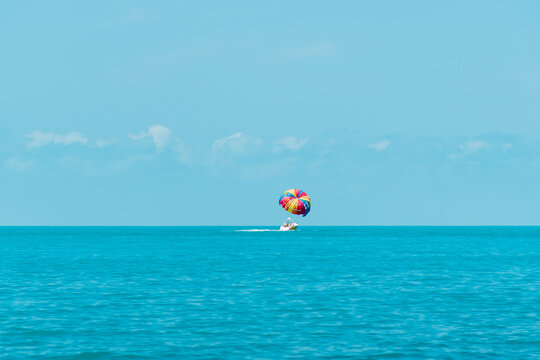 Rainbow parachute on the background of the blue sea and sky. Landscape. Summer. Vacation.
