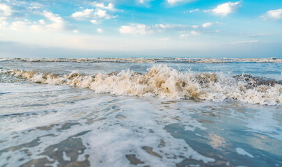 Waves on beach and blue sky with clouds landscape