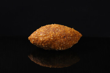 Beef kufta from lentils and bulgur. Ishli kyufta on a table with an oration. Close-up