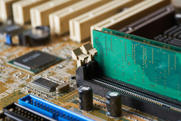Old motherboard covered in dust and dirt. Close-up.