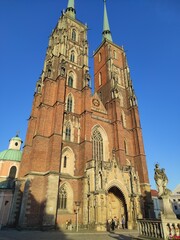 Cathedral in Wrocław, Poland. The front of the building with its towers in the sun, evening in...
