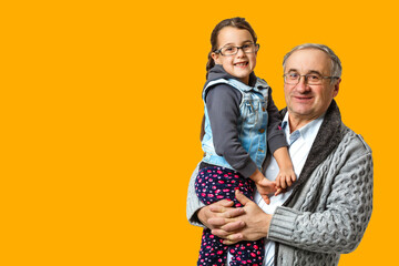 Authentic photo of smiling grandfather hugging with his granddaughter
