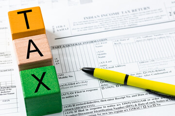 Annual tax return in India, Personal form, Wooden blocks with the word Tax