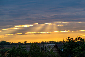 Sun Burst rays break over the clouds shining sunset Beautiful evening  Sunbeams dark rain.