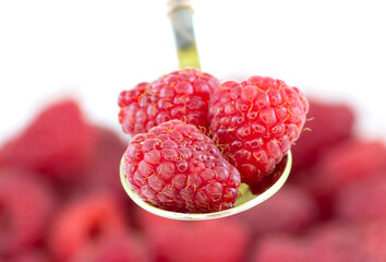 Fresh ripe raspberries on a metal spoon
