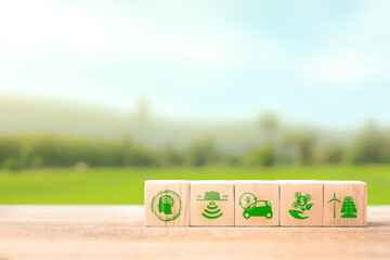 wooden cubes with eco globe on Blurred nature background, Internet of things, Smart technology with agriculture concept, Sustainable energy, Metaverse, AI Futuristic Smart virtual interface.