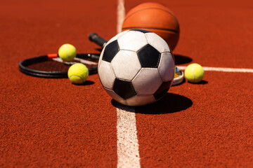 Sport games equipment - balls, rackets - on court.