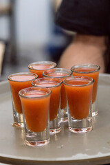 Bartender showing the customer the drink he has just prepared. Night club or party atmosphere. Classy drinks.