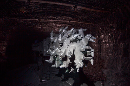 Closeup view of roadheader in mine.