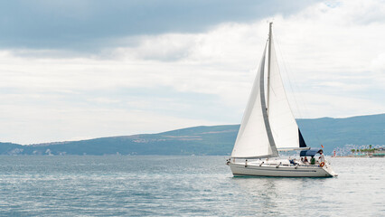 A large white sailing yacht for tourists in a blue sea against a clear sky. Tourist sailing boat....