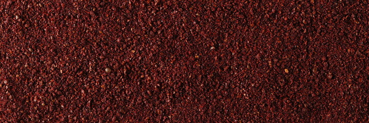 Ground sumac spice  background and texture, top view 