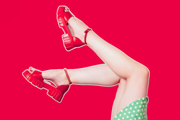 Women's legs in platform sandals on a red background.