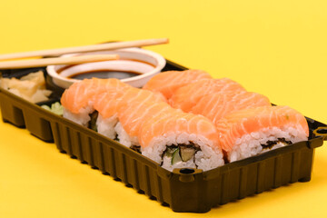 Sushi set on yellow background. Closeup selective focus.