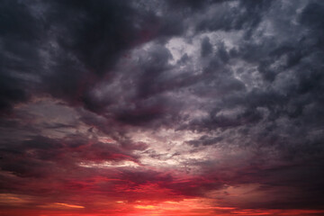 Reddish dramatic sunset or sunrise sky clouds.