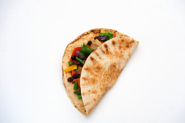 Corn tortilla tacos with vegetable filling on isolated white background. Traditional dish of Mexican cuisine or World Vegan Day.