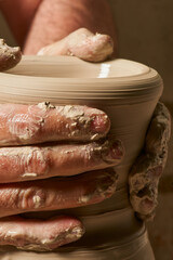 Craftsman molding a clay vase