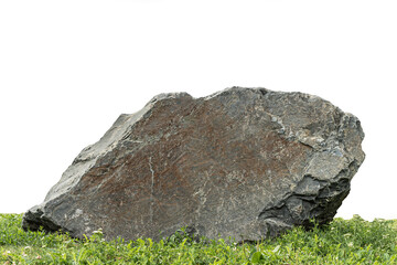 Big stone granite lump on green grass isolated on white background.