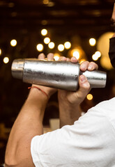Bartender preparing a cocktail. Cocktail preparation in a night environment. It can be a hotel, a restaurant or a night club.