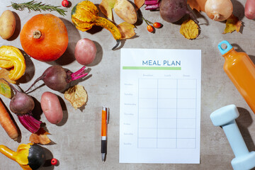autumn flat lay on concrete background with fitness dumbbell