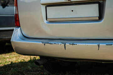 car crash or accident. Front fender and light damage and scratched on bumper. Broken vehicle detail or close up
