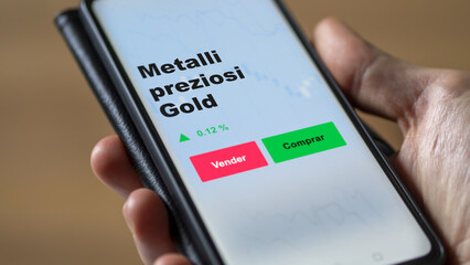 Un inversor está analizando el metalli preziosi gold etf fondo en pantalla. Un teléfono muestra...