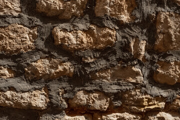 texture of a grey stone wall made of stones with concrete