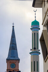 Fototapeta na wymiar Christian church and minaret of the mosque side by side in Stone Town, Zanzibar, Tanzania