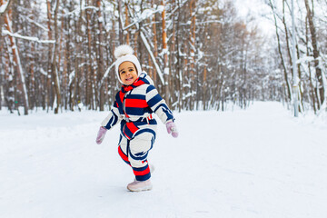 Fototapeta na wymiar little girl having fun and sledding sled playing in snowy park