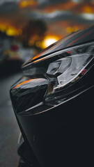 car side view in front of sunset