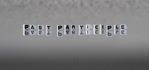 past participle word or concept represented by black and white letter cubes on a grey horizon background stretching to infinity