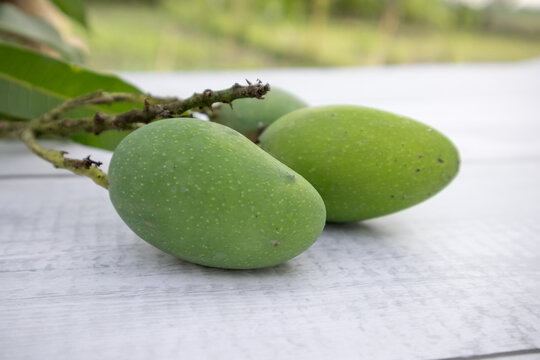 Some raw mango or kaccha aam in a wooden table