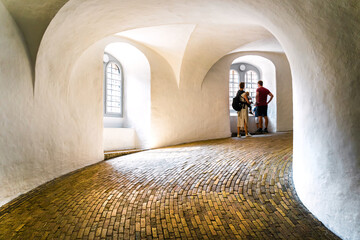Family enjoying the interior of  Round Tower (Rundetaarn), a 17th-century tower built as an...
