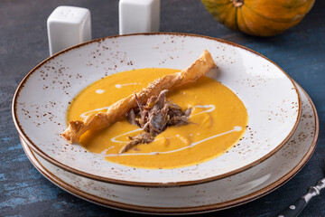 Tasty pumpkin soup with duck. Autumn soup