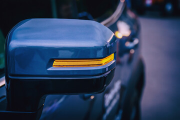 close-up of LED turn signal on side rearview mirror of car, modern automotive technology